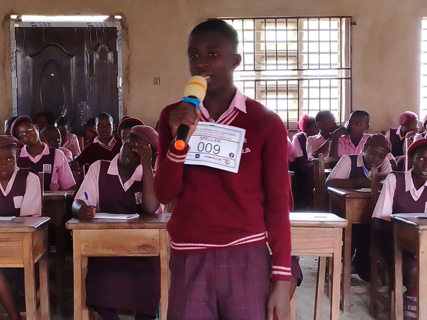 A student participating in a KCI spelling bee