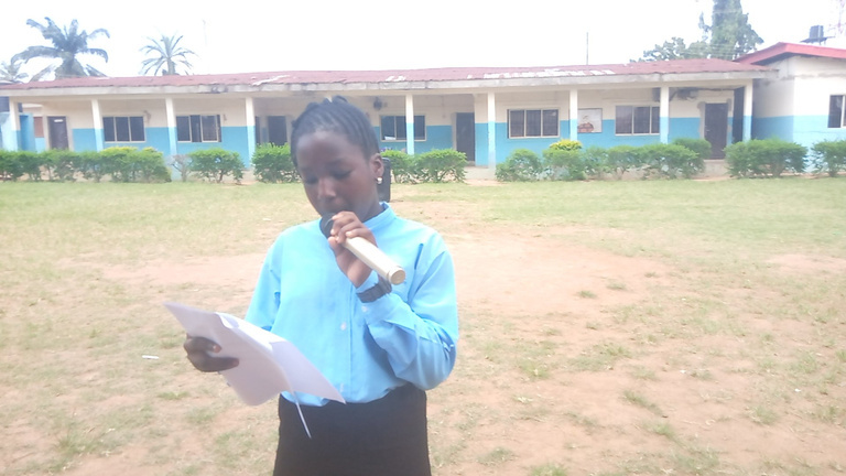 KCI student speaking during an outdoor spelling bee activity