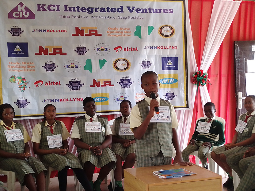 KCI spelling bee finalist speaking on stage